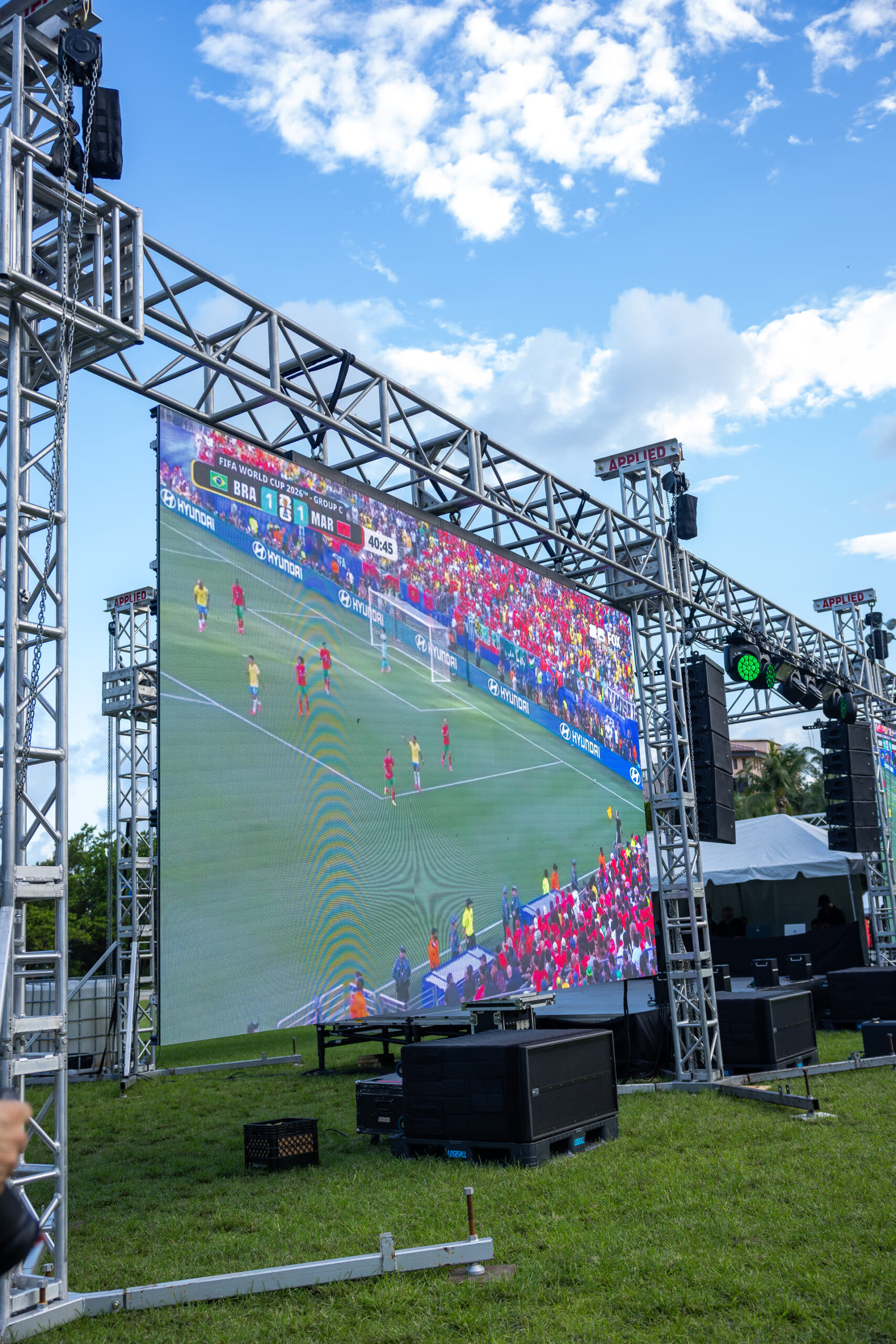 Large outdoor LED screen and line-array sound production at a Miami event