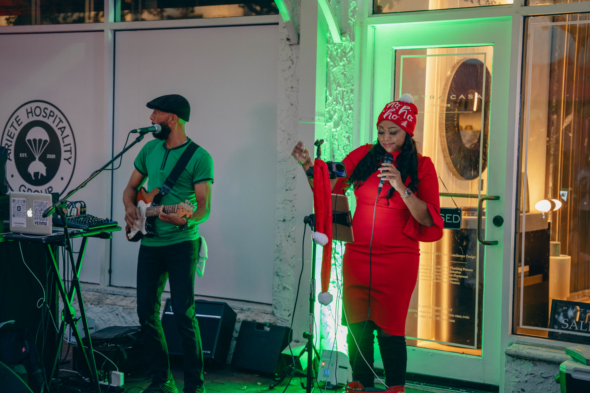 Vocalist performing under festive lighting at a Miami holiday event