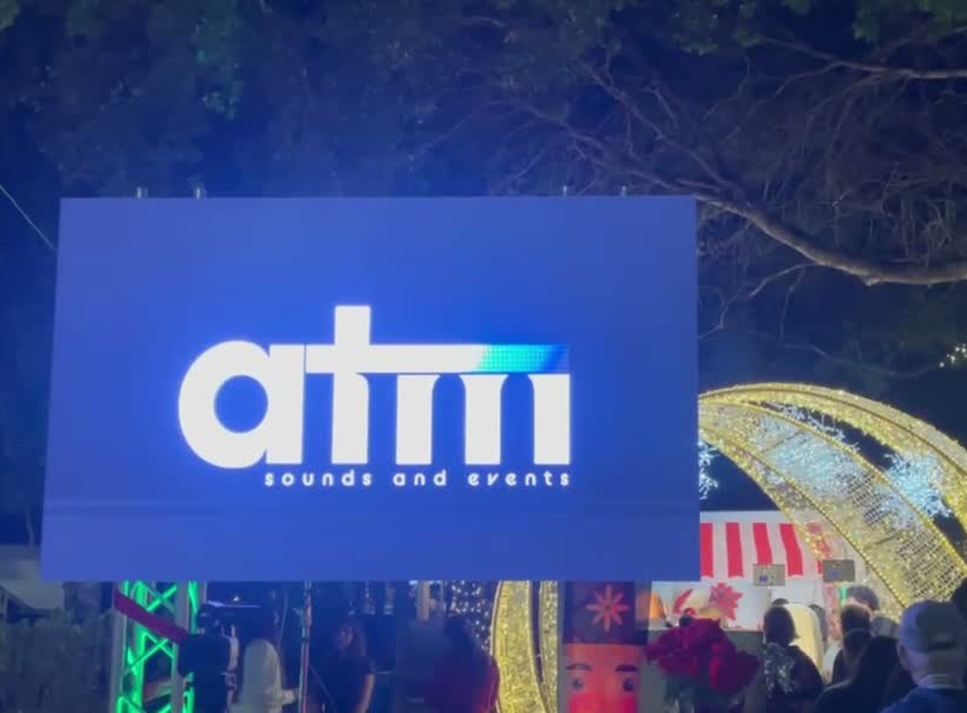 ATM Sounds and Events logo displayed on a large LED video wall at the Coconut Grove Tree Lighting