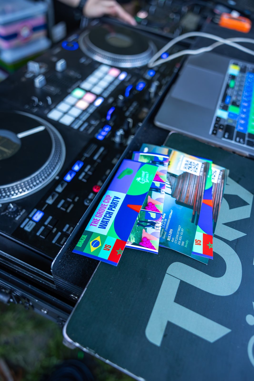 DJ controller and mixer lit at night