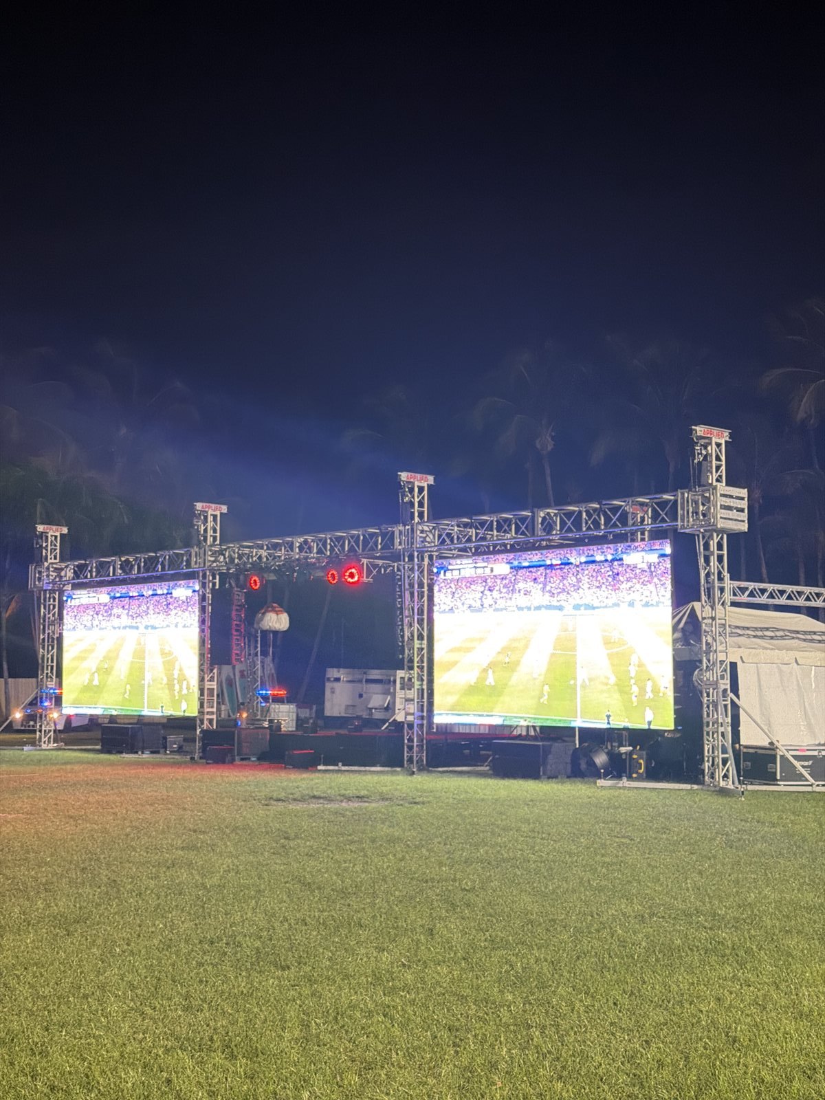 Two LED video walls lit at night above the crowd