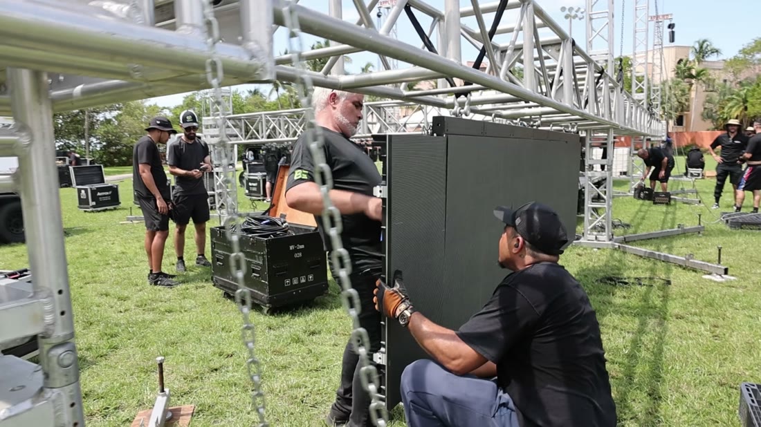ATM crew chaining LED panels onto the truss structure